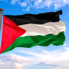 Palestinian flag waving under cloudy sky