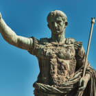 Rome, Bronze statue of emperor Caesar Augustus, Forum of Augustus in the background