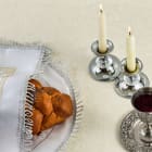 Sabbath Table Setting. Elegant Sabbath table with braided bread, candles, and wine cup.