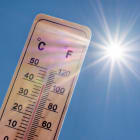 Thermomètre affichant une température élevée en degrés Celsius et Fahrenheit avec un soleil rayonnant sur fond de ciel bleu. Concepts d&rsquo;été, de beau temps, de chaleur excessive et de canicule