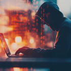 Cyber hacker attack concept. Abstract digital hacker man with a laptop. Male criminal, hoodie and ready for coding, cyber-attack and programming for malware with tech, scam and data