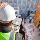 civil engineer or architect on construction site checking schedu