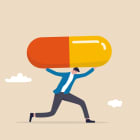Medical debt, health care and treatment cost from Covid-19 disease, hospital expense or drug and medicine bills concept, broke bankrupt man carrying giant medicine debt burden after cure from COVID-19